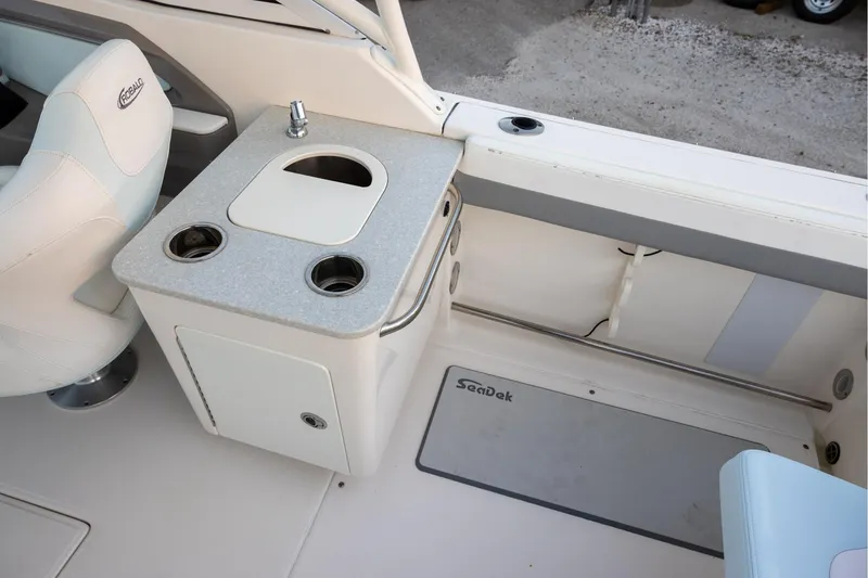 Slide: The Image of 2020 Robalo R247 Dual Console boat interior with seating and utility area. - 6
