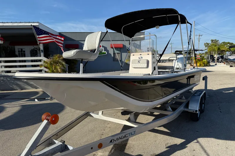 Slide: The Image of 2026 Carolina Skiff E20 JVX CC boat on trailer, parked outside dealership. - 2
