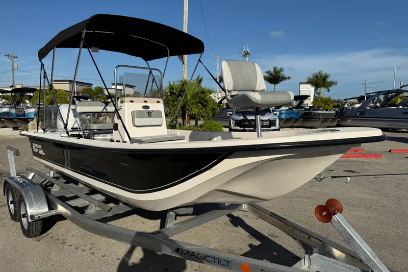 Slide: The Image of 2026 Carolina Skiff E20 JVX CC boat with Suzuki engine on trailer, parked outdoors. - 4