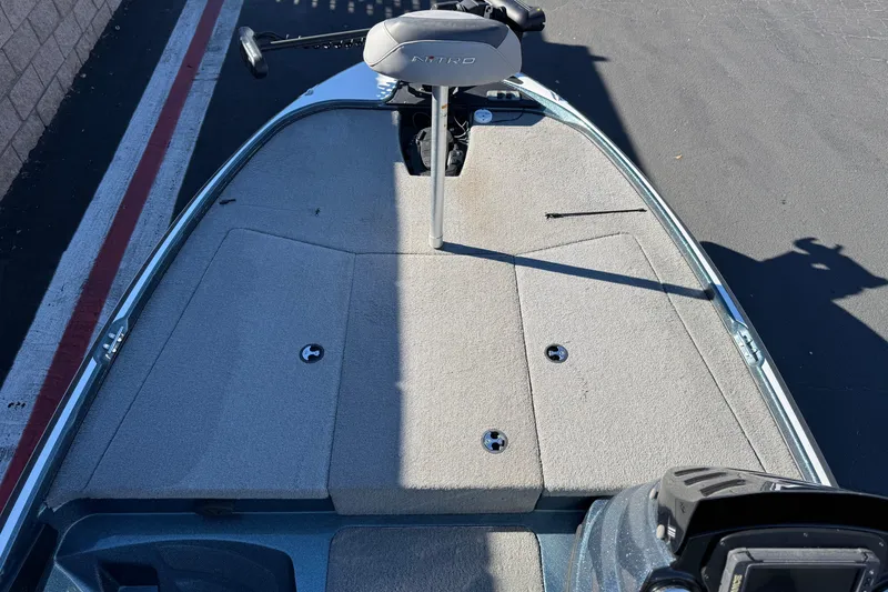 Slide: The Image of 2019 Nitro Z17 boat deck with trolling motor and carpeted surface. - 12