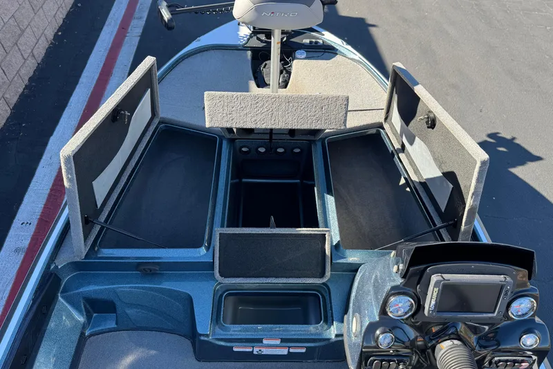 Slide: The Image of 2019 Nitro Z17 boat with open storage compartments and control panel. - 13