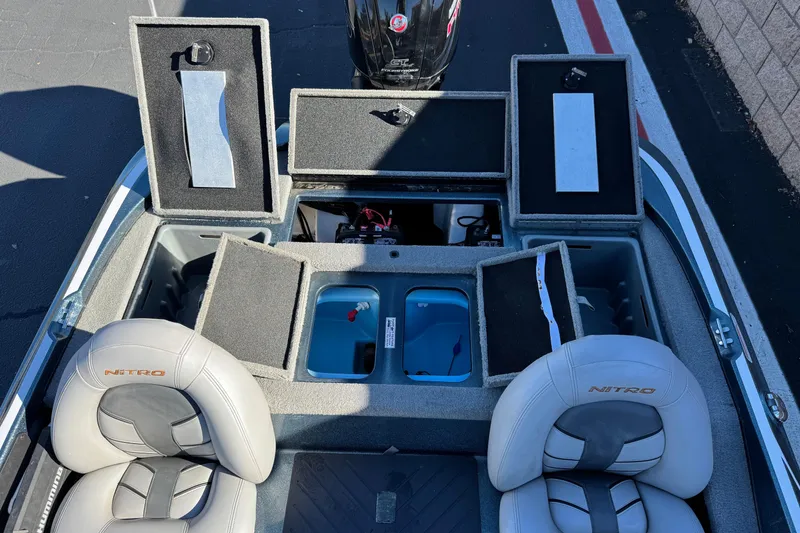 Slide: The Image of 2019 Nitro Z17 boat interior with open storage compartments and seats. - 17