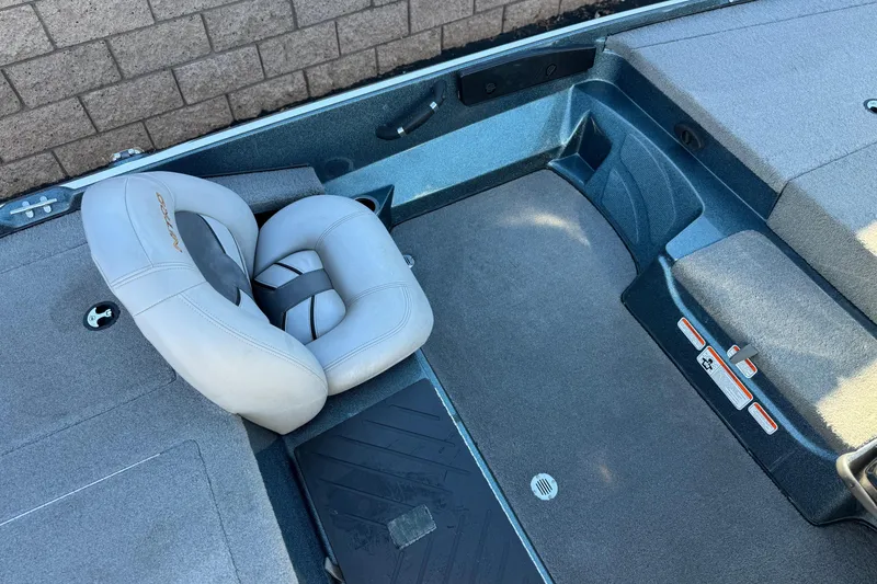 Slide: The Image of 2019 Nitro Z17 boat interior with gray seating and carpeted flooring. - 18