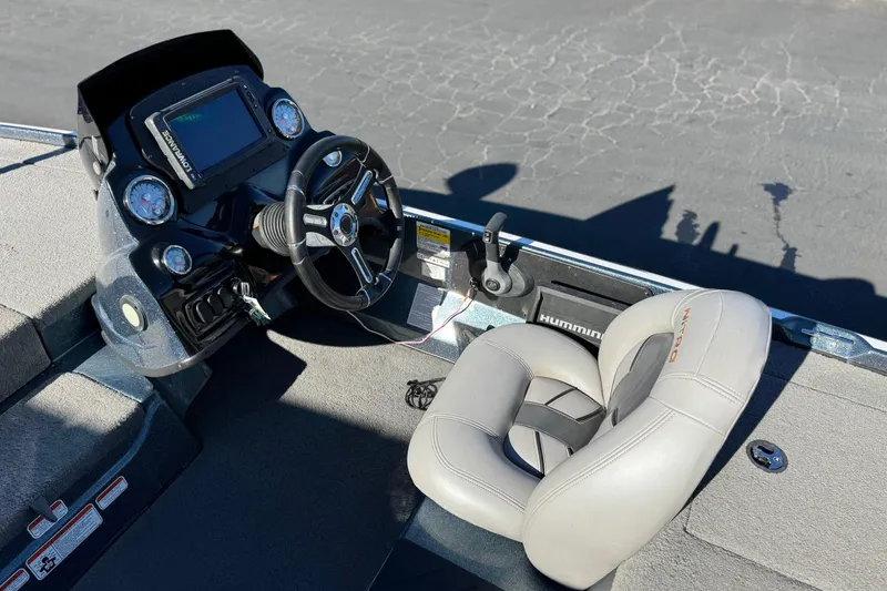 Slide: The Image of 2019 Nitro Z17 boat cockpit with steering wheel and cushioned seat. - 19