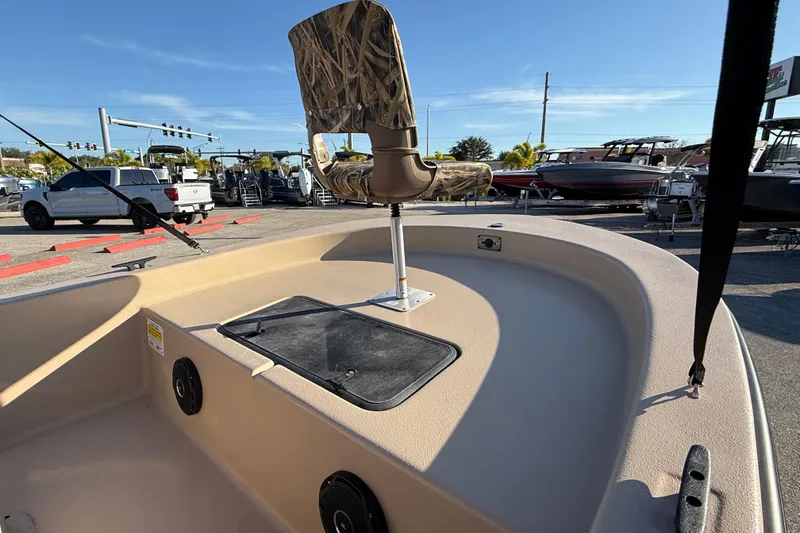 Slide: The Image of 2025 Carolina Skiff E18 JVX CC Sportman Edition boat interior with camo seat and storage. - 15