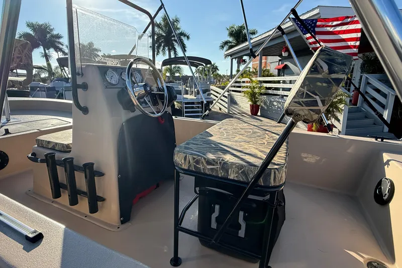 Slide: The Image of 2025 Carolina Skiff E18 JVX CC Sportman Edition boat interior with steering console and seating. - 20