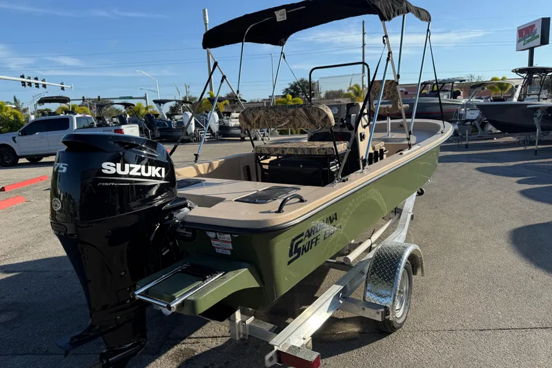Slide: The Image of 2025 Carolina Skiff E18 JVX CC Sportman Edition with Suzuki engine on trailer. - 7
