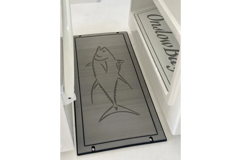 Slide: The Image of 2023 Onslow Bay 27 Offshore boat deck with fish design and logo detail. - 10