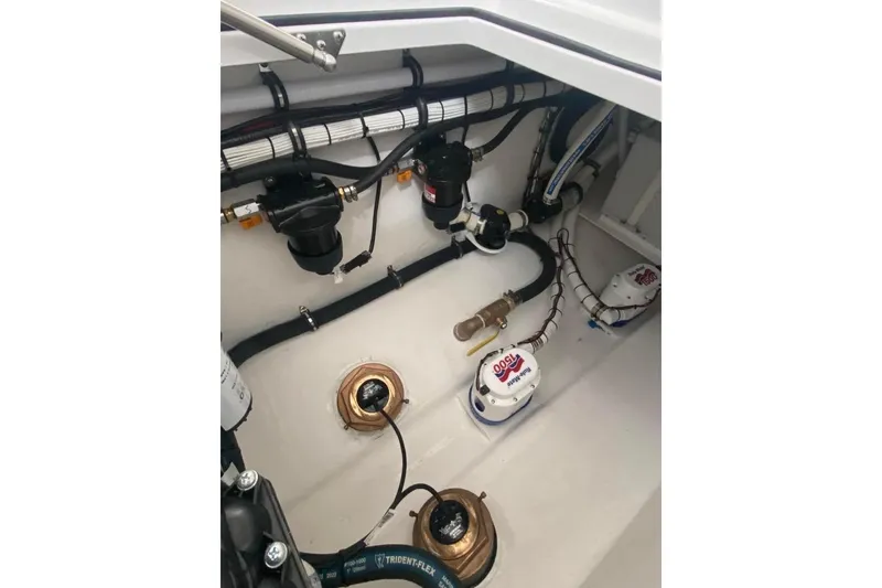 Slide: The Image of Engine compartment of 2023 Onslow Bay 27 Offshore boat, showcasing pumps and wiring. - 12