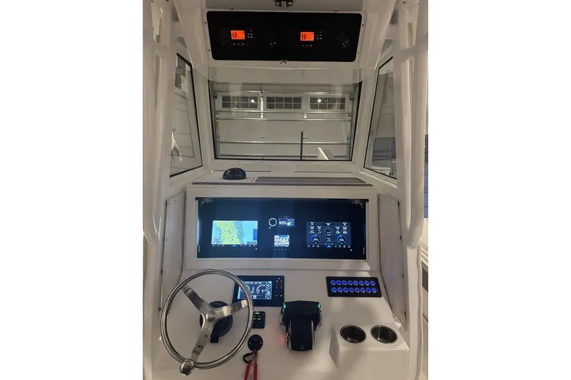 Slide: The Image of 2023 Onslow Bay 27 Offshore boat dashboard with modern navigation and control systems. - 8