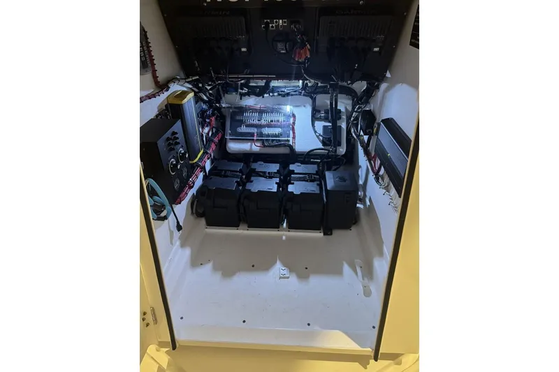 Slide: The Image of Electrical compartment of 2023 Onslow Bay 27 Offshore boat, showcasing wiring and battery setup. - 9