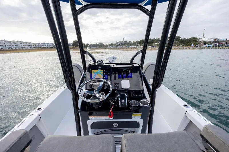 Slide: The Image of 2024 Sea Pro 228 Bay boat dashboard with navigation system on calm water. - 18