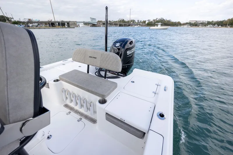 Slide: The Image of 2024 Sea Pro 228 Bay boat on water, featuring Suzuki outboard motor. - 21