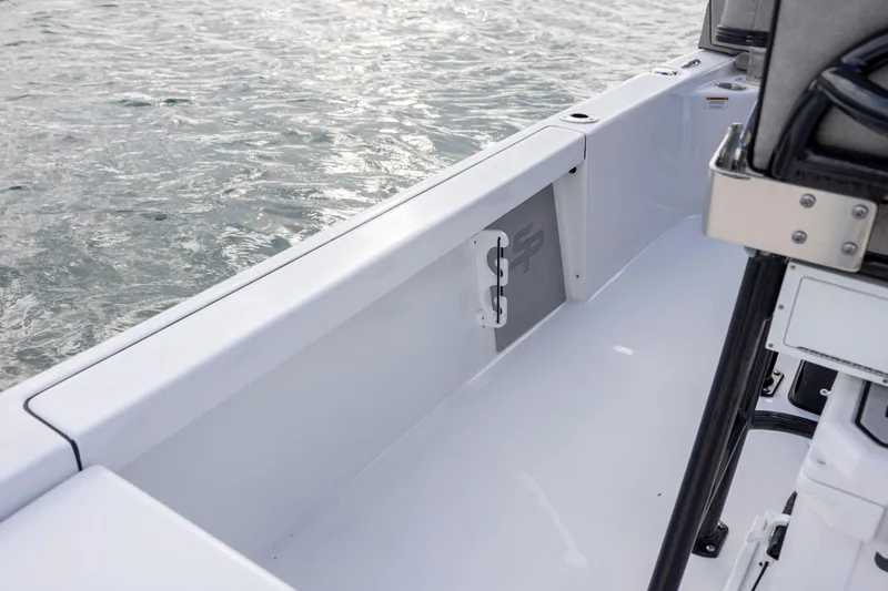 Slide: The Image of 2024 Sea Pro 228 Bay boat interior detail with water in the background. - 26
