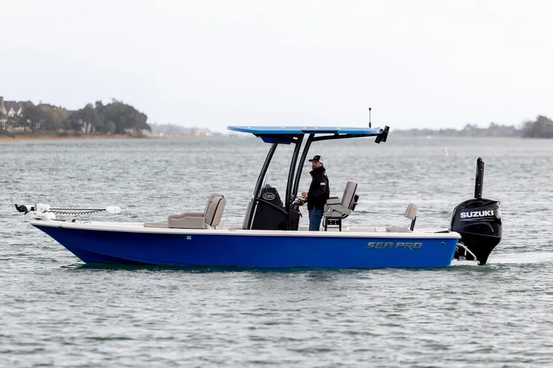 Slide: The Image of 2024 Sea Pro 228 Bay boat on water, featuring Suzuki outboard motor. - 4