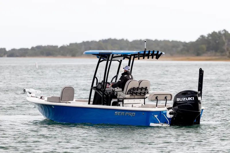 Slide: The Image of 2024 Sea Pro 228 Bay boat with Suzuki engine cruising on a calm lake. - 5