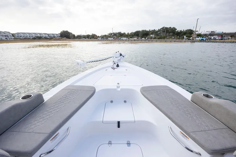 Slide: The Image of 2024 Sea Pro 228 Bay boat interior with seating and water view. - 9