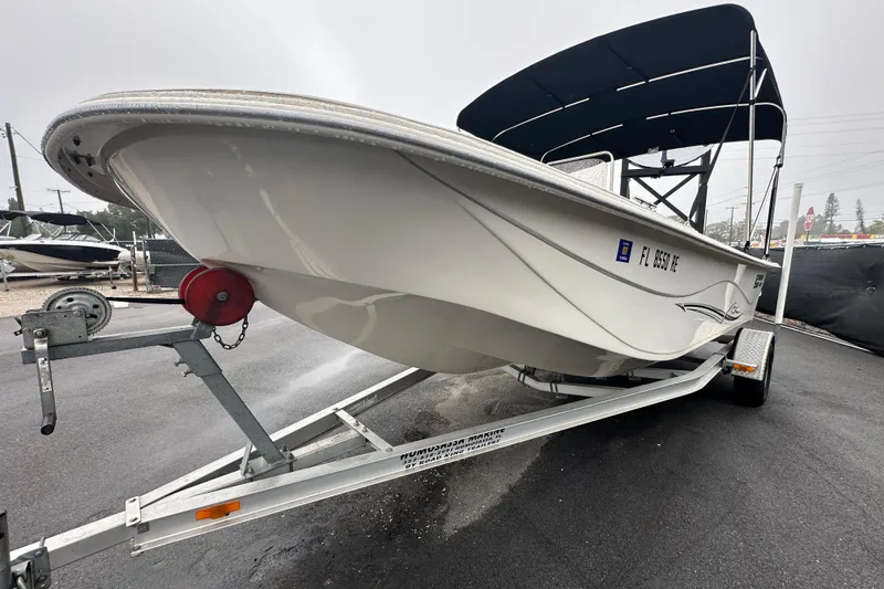 Slide: The Image of 2016 Carolina Skiff 218 DLV boat on trailer, sunlit, outdoor display. - 10