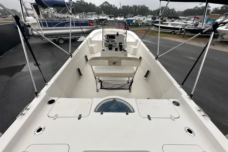 Slide: The Image of 2016 Carolina Skiff 218 DLV boat on display in a parking lot. - 12