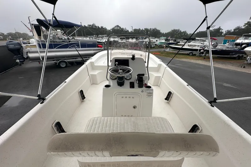 Slide: The Image of 2016 Carolina Skiff 218 DLV boat interior with steering console and seating. - 16