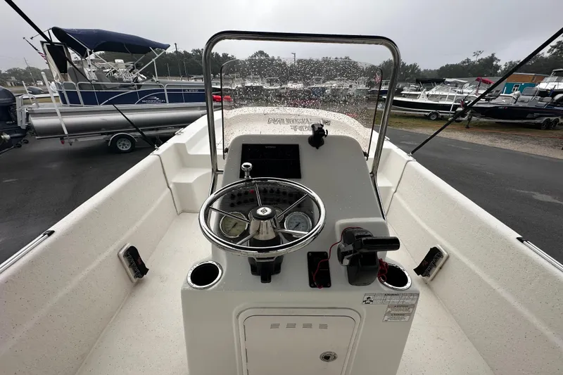 Slide: The Image of 2016 Carolina Skiff 218 DLV boat interior with steering console and seating. - 17