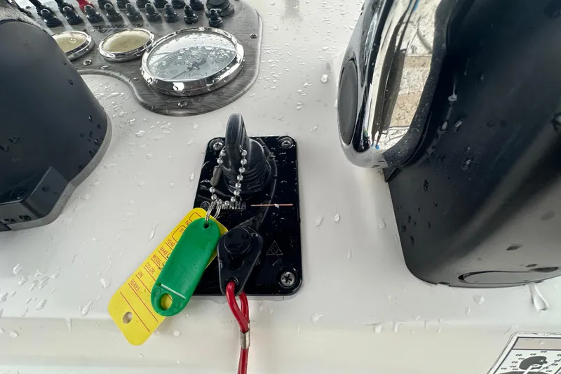 Slide: The Image of 2016 Carolina Skiff 218 DLV boat deck with storage compartments, parked in a marina. - 28