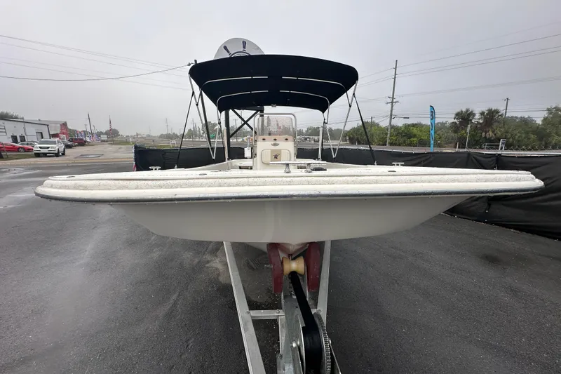Slide: The Image of 2016 Carolina Skiff 218 DLV boat with Yamaha outboard motor, parked on a trailer. - 3
