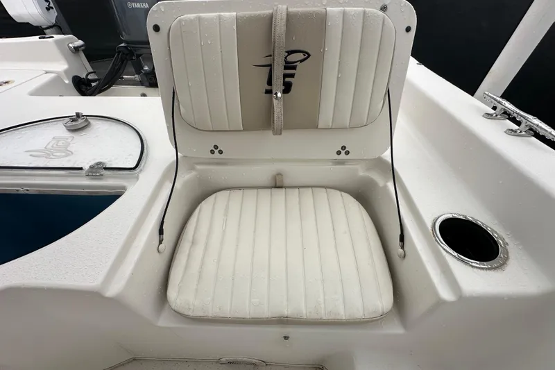 Slide: The Image of 2016 Carolina Skiff 218 DLV boat interior with seating and storage compartments. - 40