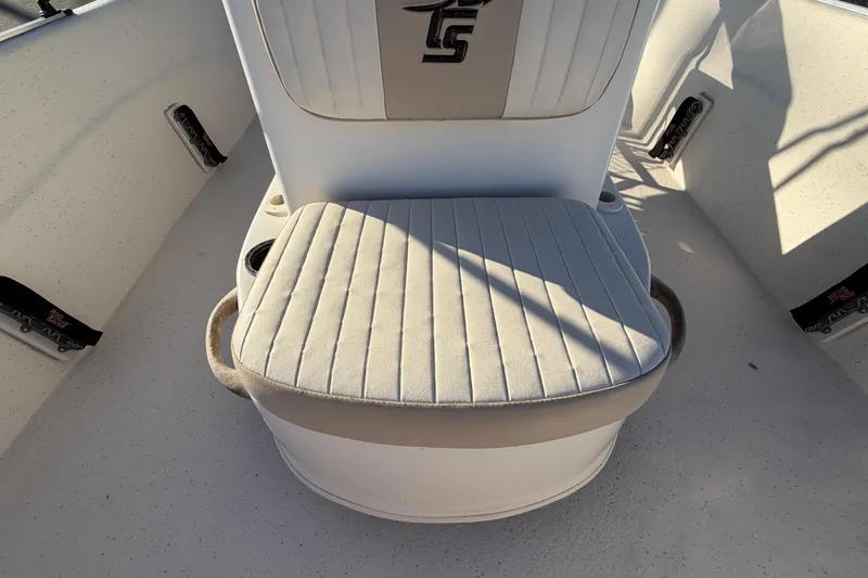Slide: The Image of 2016 Carolina Skiff 218 DLV boat seat with cushioned backrest and cup holders. - 43