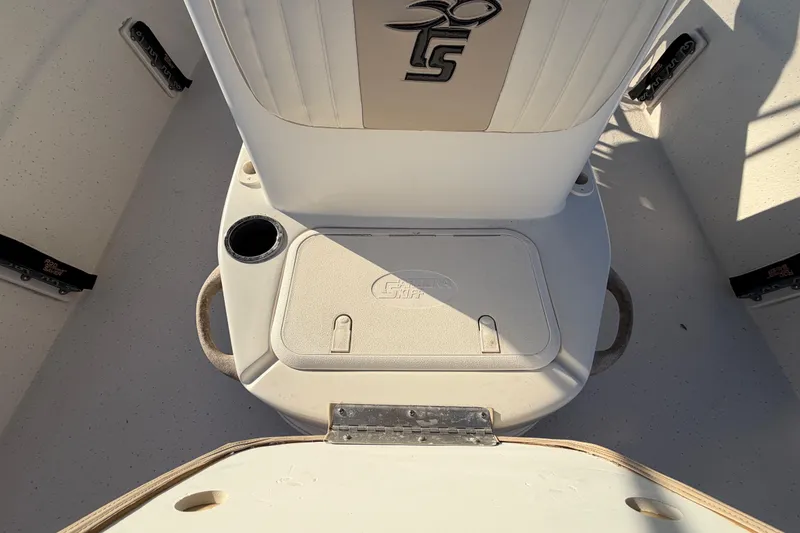 Slide: The Image of 2016 Carolina Skiff 218 DLV boat interior with storage compartment and cup holder. - 44