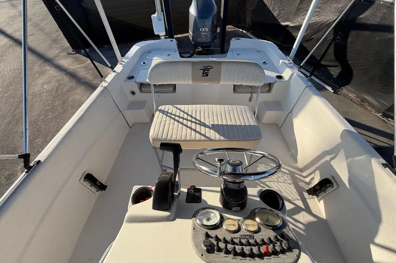 Slide: The Image of 2016 Carolina Skiff 218 DLV boat interior with steering wheel and controls. - 46