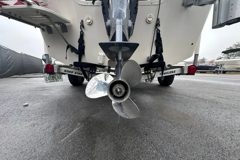 Slide: The Image of 2016 Carolina Skiff 218 DLV boat with 115 horsepower engine at a sales lot. - 5