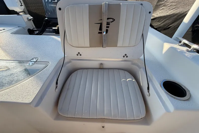 Slide: The Image of 2016 Carolina Skiff 218 DLV boat seat with storage compartment and cup holder. - 50