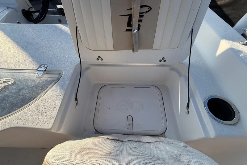 Slide: The Image of 2016 Carolina Skiff 218 DLV boat storage compartment with open hatch. - 51