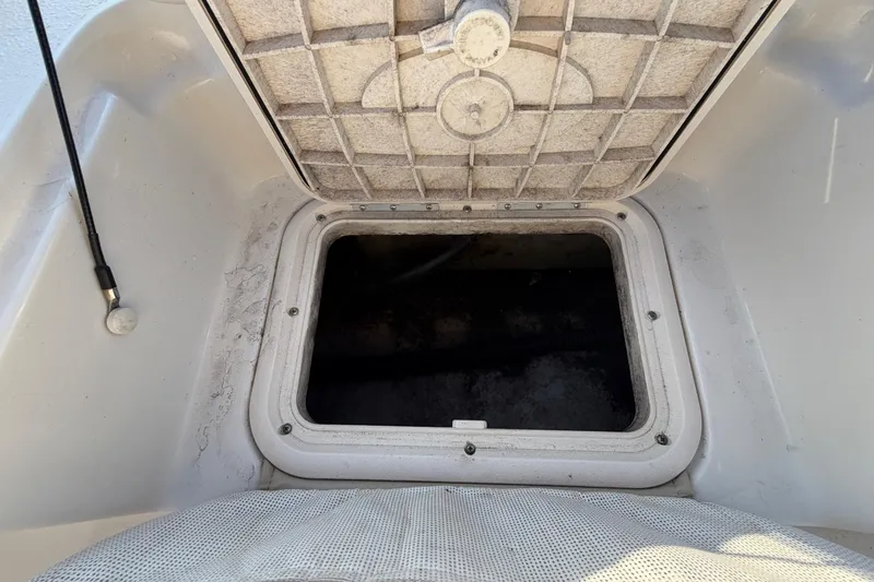Slide: The Image of Open storage compartment on a 2016 Carolina Skiff 218 DLV boat. - 58