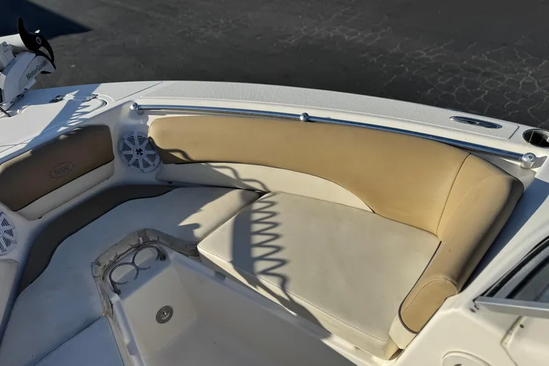 Slide: The Image of 2016 Key West 211 Dual Console boat interior with beige seating and cup holders. - 15
