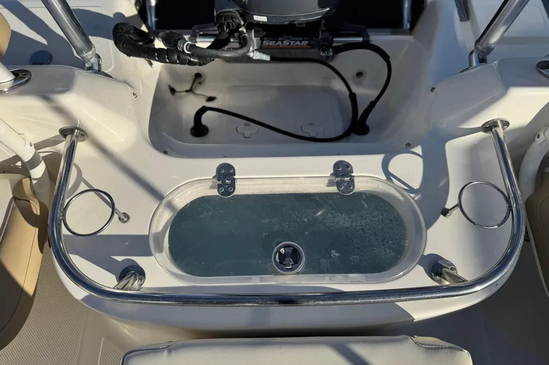 Slide: The Image of 2016 Key West 211 Dual Console boat interior with livewell and cup holders. - 19