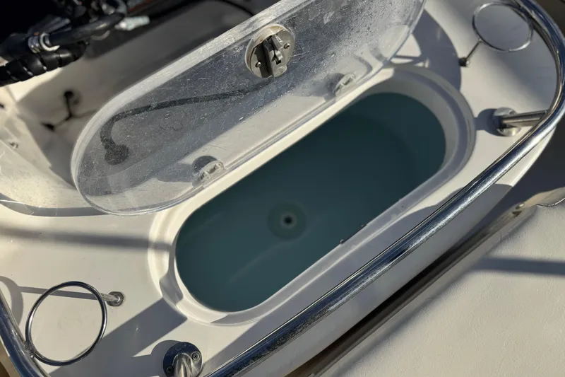 Slide: The Image of Open livewell on 2016 Key West 211 Dual Console boat, featuring stainless steel railing. - 20