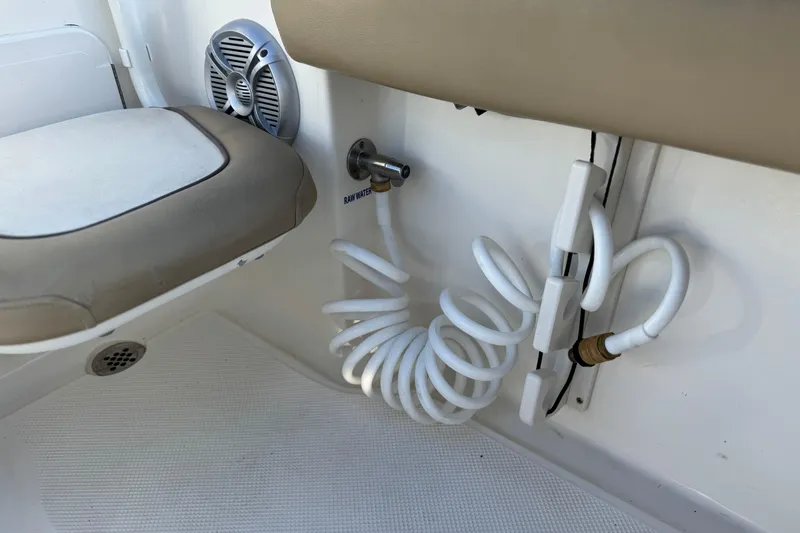 Slide: The Image of Interior of 2016 Key West 211 Dual Console boat with coiled hose and speaker. - 21