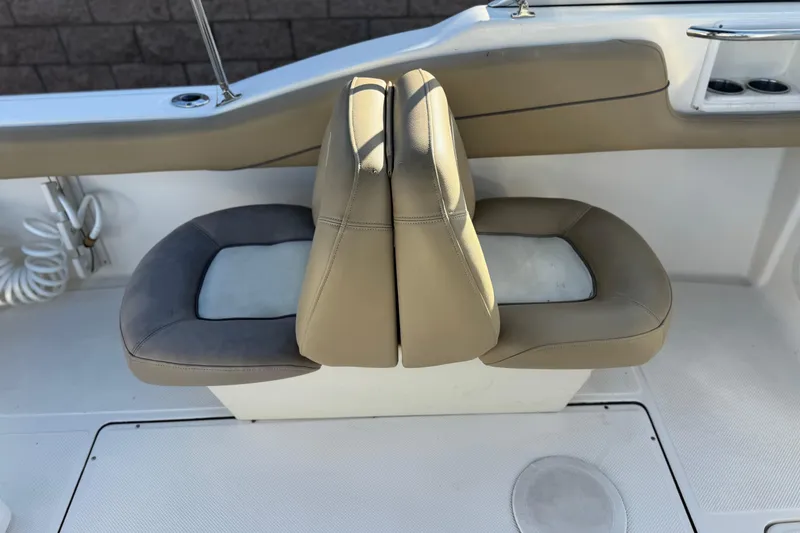 Slide: The Image of 2016 Key West 211 Dual Console boat seat, beige and gray upholstery, interior view. - 24