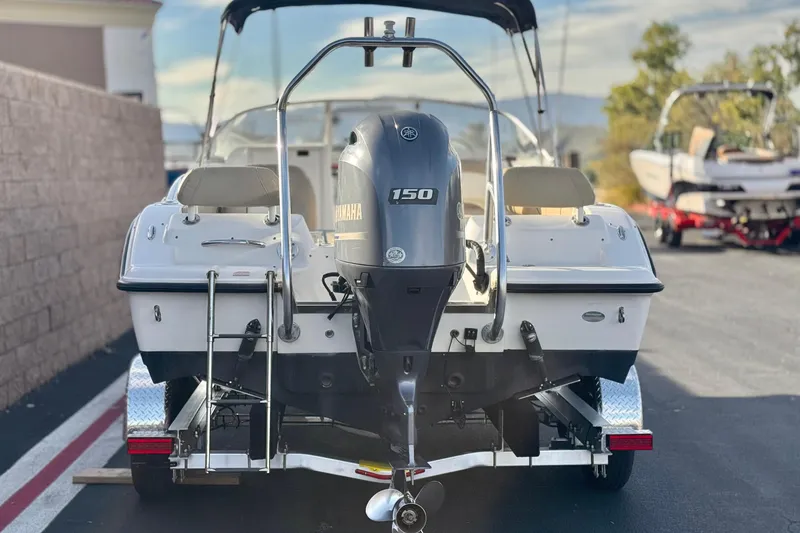 Slide: The Image of 2016 Key West 211 Dual Console boat with Yamaha 150 engine on trailer. - 4