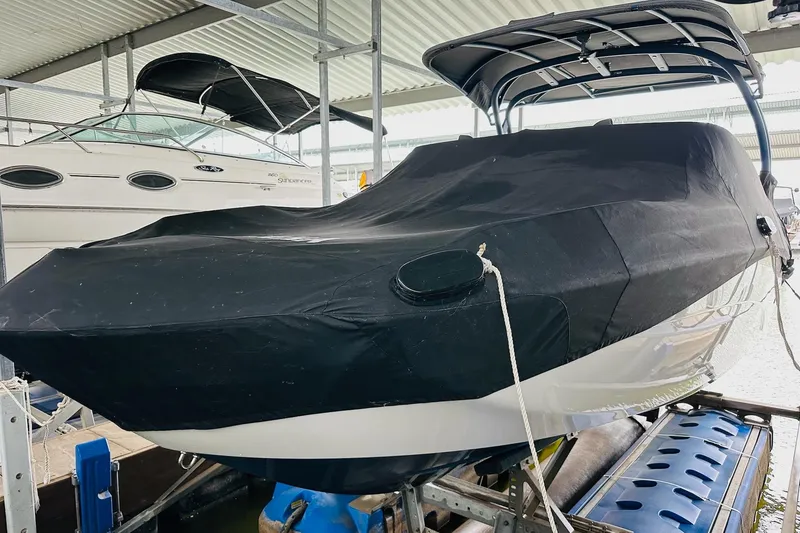 Slide: The Image of 2020 Yamaha Boats 242SE covered and docked in a marina. - 11