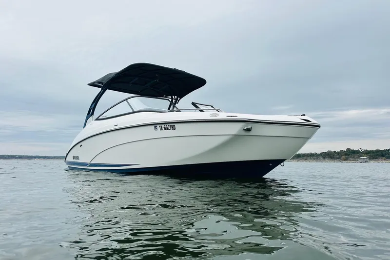 Slide: The Image of 2020 Yamaha Boats 242SE on calm water, showcasing sleek design and modern features. - 2