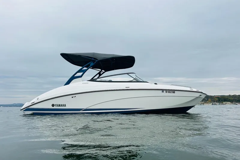 Slide: The Image of 2020 Yamaha Boats 242SE on calm water, featuring sleek design and modern canopy. - 3