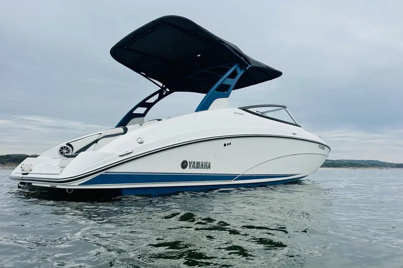 Slide: The Image of 2020 Yamaha Boats 242SE on calm water, featuring sleek design and modern canopy. - 4