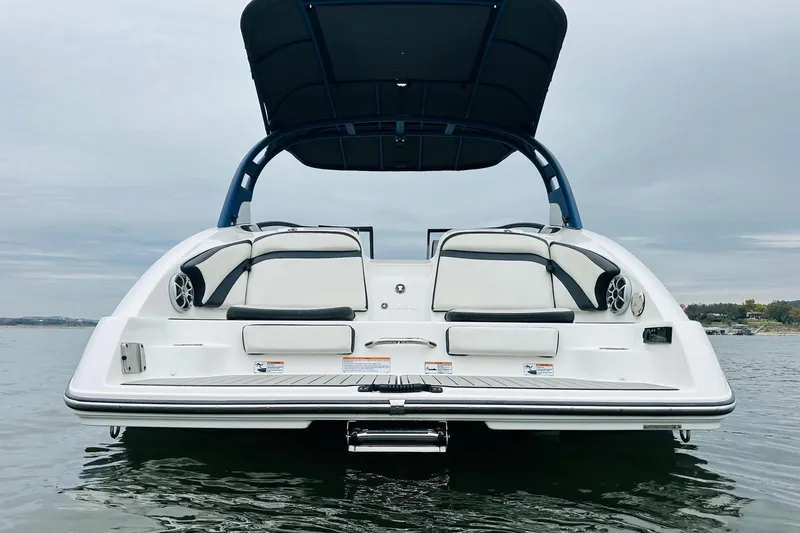 Slide: The Image of 2020 Yamaha Boats 242SE, rear view on water, showcasing sleek design and seating. - 5