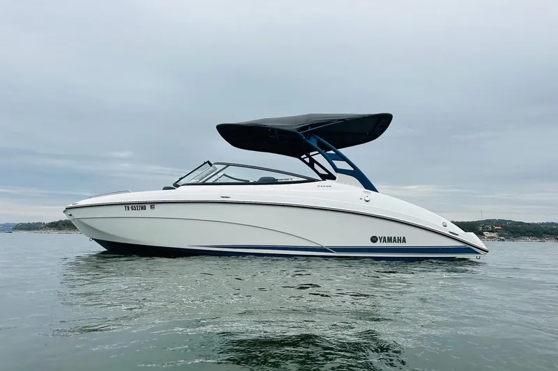 Slide: The Image of 2020 Yamaha Boats 242SE on calm water, featuring sleek design and canopy. - 7