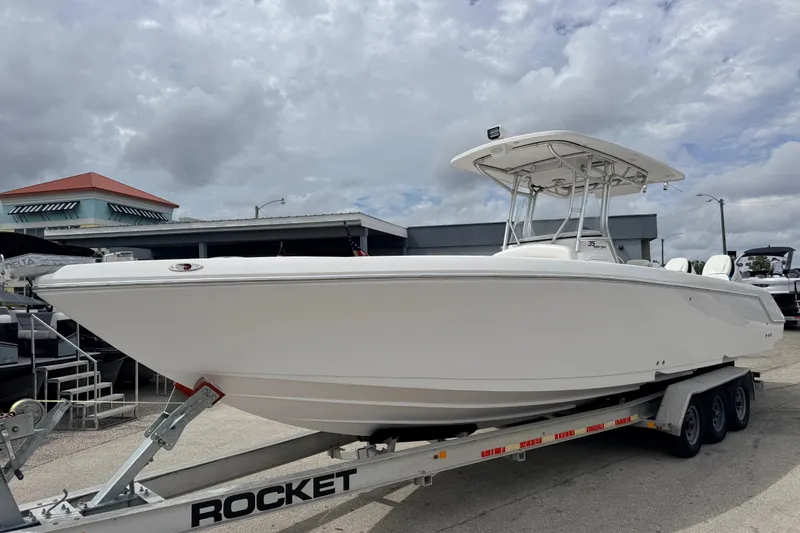 The Image of 2016 Pro-Line 35 Super Sport boat on trailer under cloudy sky. - 0