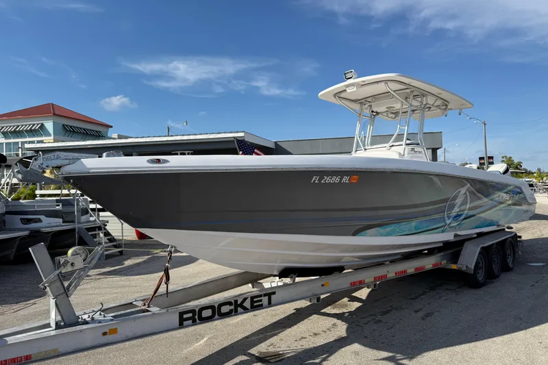 Slide: The Image of 2016 Pro-Line 35 Super Sport boat on trailer, parked outdoors under clear blue sky. - 1