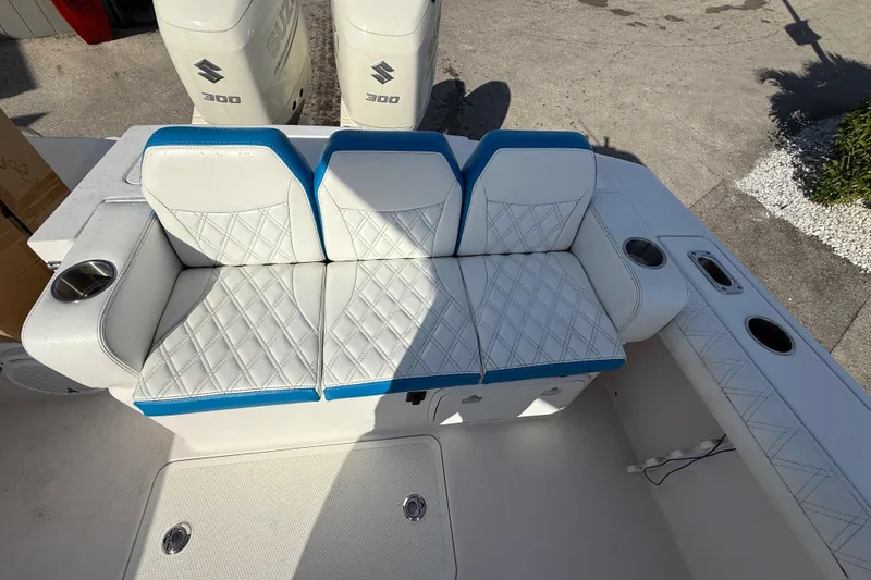 Slide: The Image of 2016 Pro-Line 35 Super Sport boat seating with diamond-stitched upholstery and Suzuki 300 engines. - 15